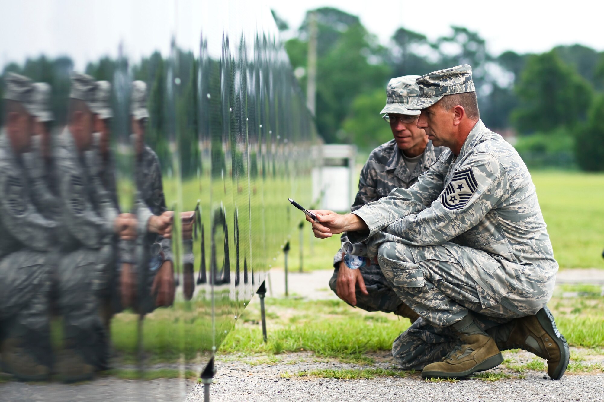 EGLIN AIR FORCE BASE, Fla. -- Command Chiefs Thomas Westermeyer, 96th Air Base Wing, and William Harner, 53d Wing, look at the name, Capt. Lance P. Sijan, at the traveling Vietnam Veterans Memorial Wall. Capt. Sijan was an Air Force officer and fighter pilot who was posthumously awarded the Medal of Honor, the United States' highest military award in 1976.  The Wall will be at the C.H. Bull Rigdon Fairgrounds through June 20. (courtesy photo/Aislinn Bailey)

