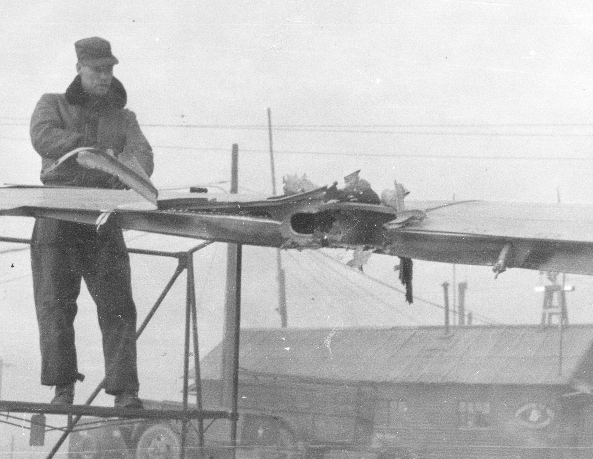 On Jan. 11, 1951, 1st Lt. James Pragar was flying "The Speaker" when antiaircraft fire ripped through the left wing. Here, a groundcrewman surveys the damage. (U.S. Air Force photo)