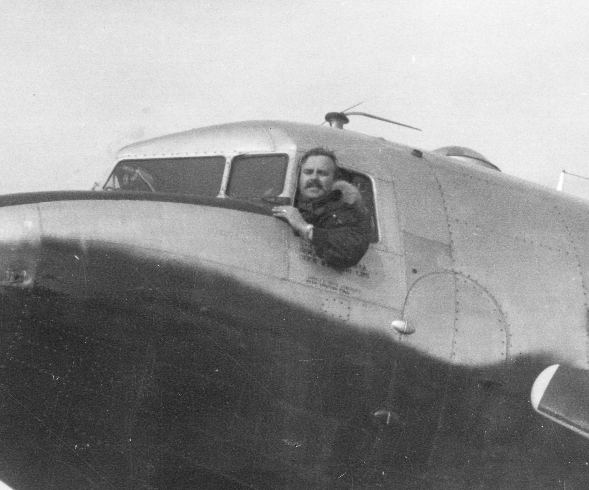 1st Lt. James Pragar in the cockpit of a C-47 used to drop agents and leaflets. The underside of the aircraft was painted black to make it harder to see from the ground at night. (U.S. Air Force photo)