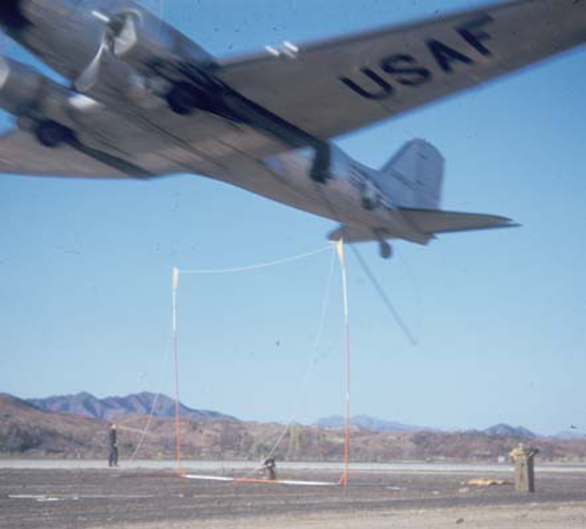 Air Force special operation aircrews experimented with “snatching” personnel from the ground via a hook on a low-flying C-47. (U.S. Air Force photo)
