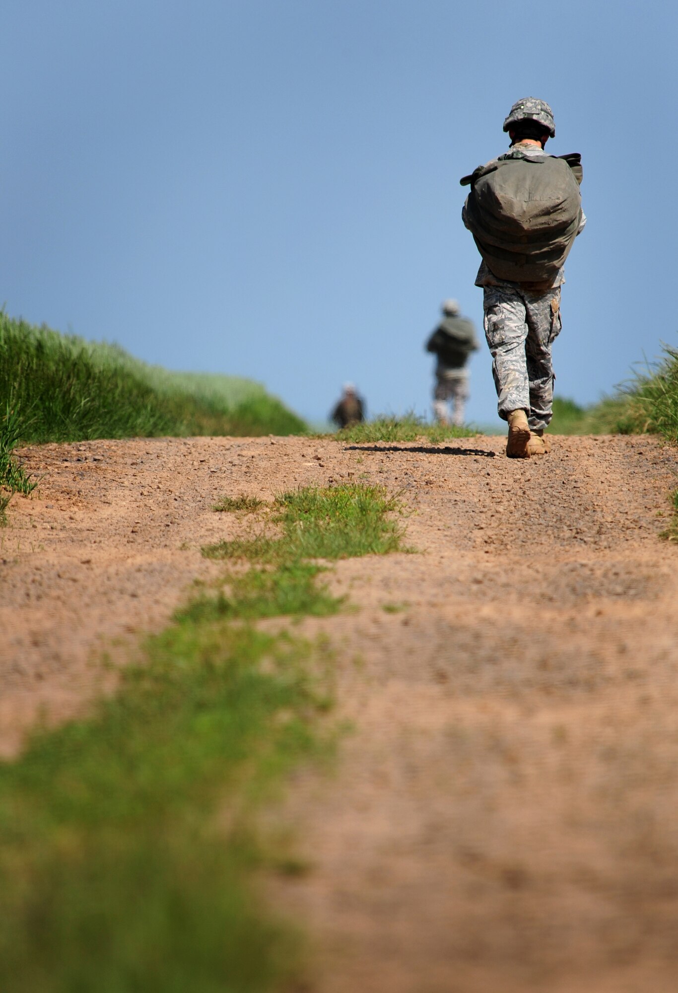 A U.S. Army soldier makes his way back to a rally point from a drop zone after a jump over Alzey, Germany, June 16, 2010. This airborne jump is part of what is  officially known as NATO Jump Week and is the first time a NATO jump is conducted from a C-17. Five NATO countries participated in this annual event to support one of United States Air Forces in Europe's top priorities; building partnership.(U.S. Air Force photo by Staff Sgt. Jocelyn Rich)