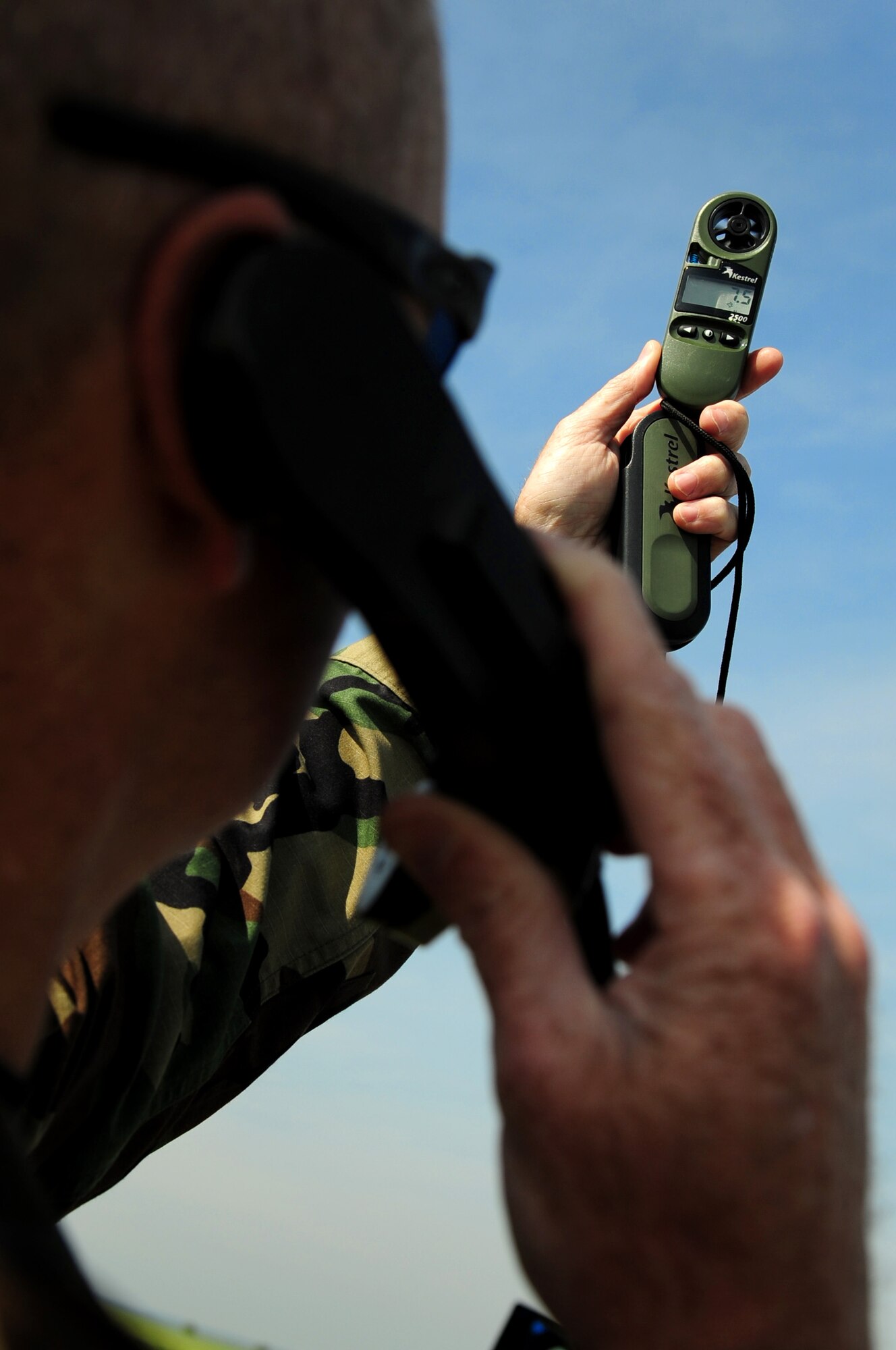 U.S. Air Force Master Sgt. Gregory McMillan, 435th Security Forces Squadron, takes a wind speed reading at a drop zone while relaying the information to the aircraft carrying paratroopers conducting a jump on his location, Alzey, Germany, June 16, 2010. This jump is part of what is officially known as NATO Jump Week and is the first time a NATO jump is conducted from a C-17. Five NATO countries participated in this annual event to support one of United States Air Forces in Europe's top priorities; building partnership.(U.S. Air Force photo by Staff Sgt. Jocelyn Rich)