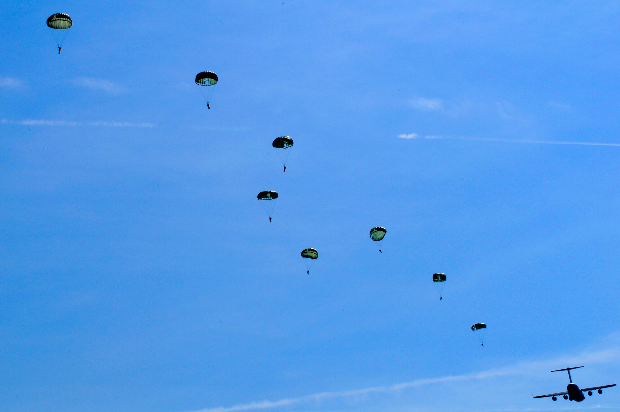 U.S. Air Force paratroopers jump from a C-17 Globemaster III, Alzey, Germany, June 16, 2010. This airborne jump is officially known as NATO Jump Week and is the first time a NATO jump is conducted from a C-17. Five NATO countries participated in the annual event to support one of United States Air Forces in Europe's top priorities; building partnerships. (U.S. Air Force photo by Airman 1st Class Brea Miller)