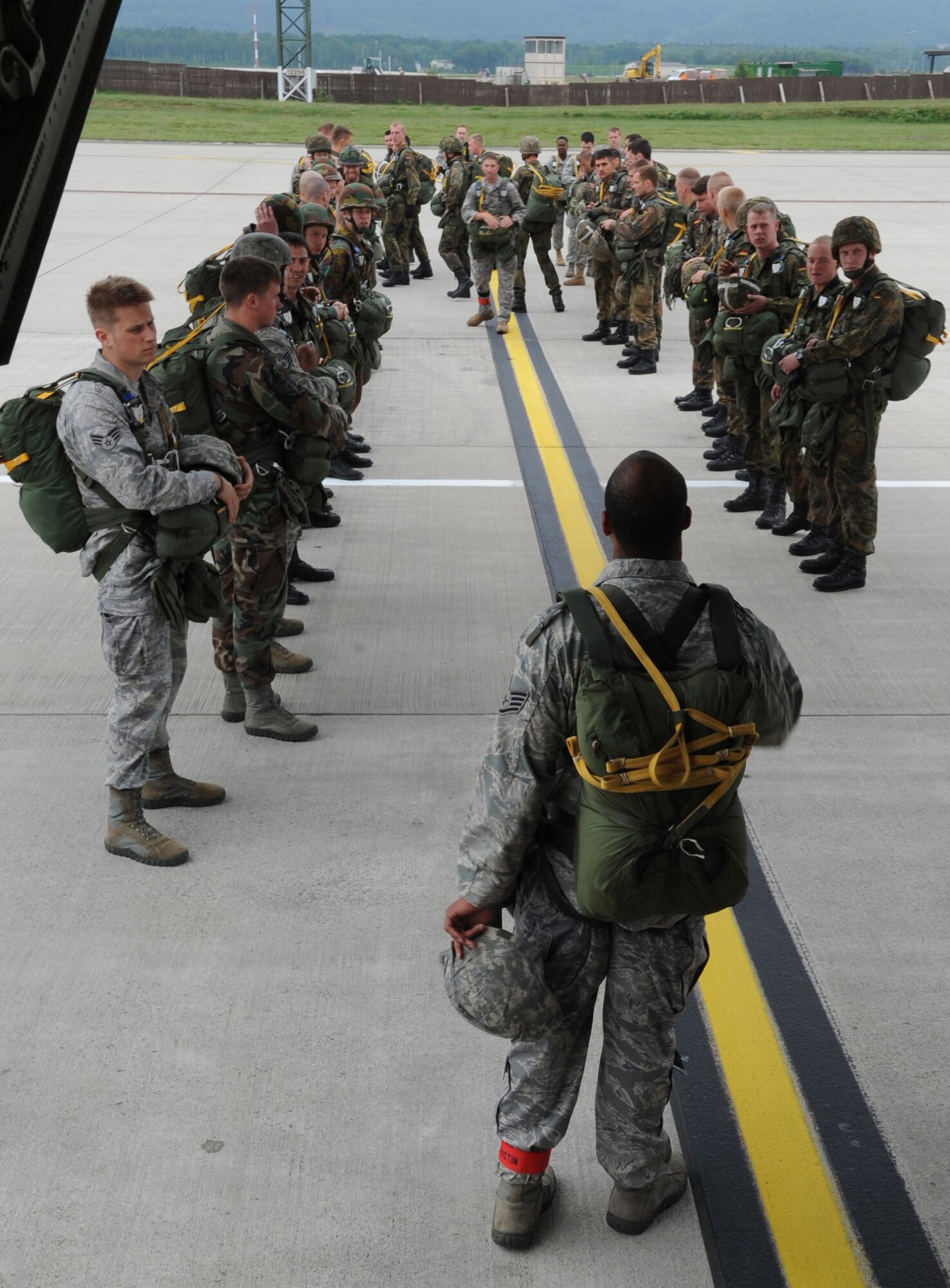 Airborne troops wait to depart for a static line jump from a C-130J as part of the NATO jump week, Ramstein Air Base, Germany, June 15, 2010. Five NATO countries participated in the annual event to support one of United States Air Forces in Europe's top priorities; building partnerships. (U.S. Air Force photo by Airman 1st Class Caleb Pierce)