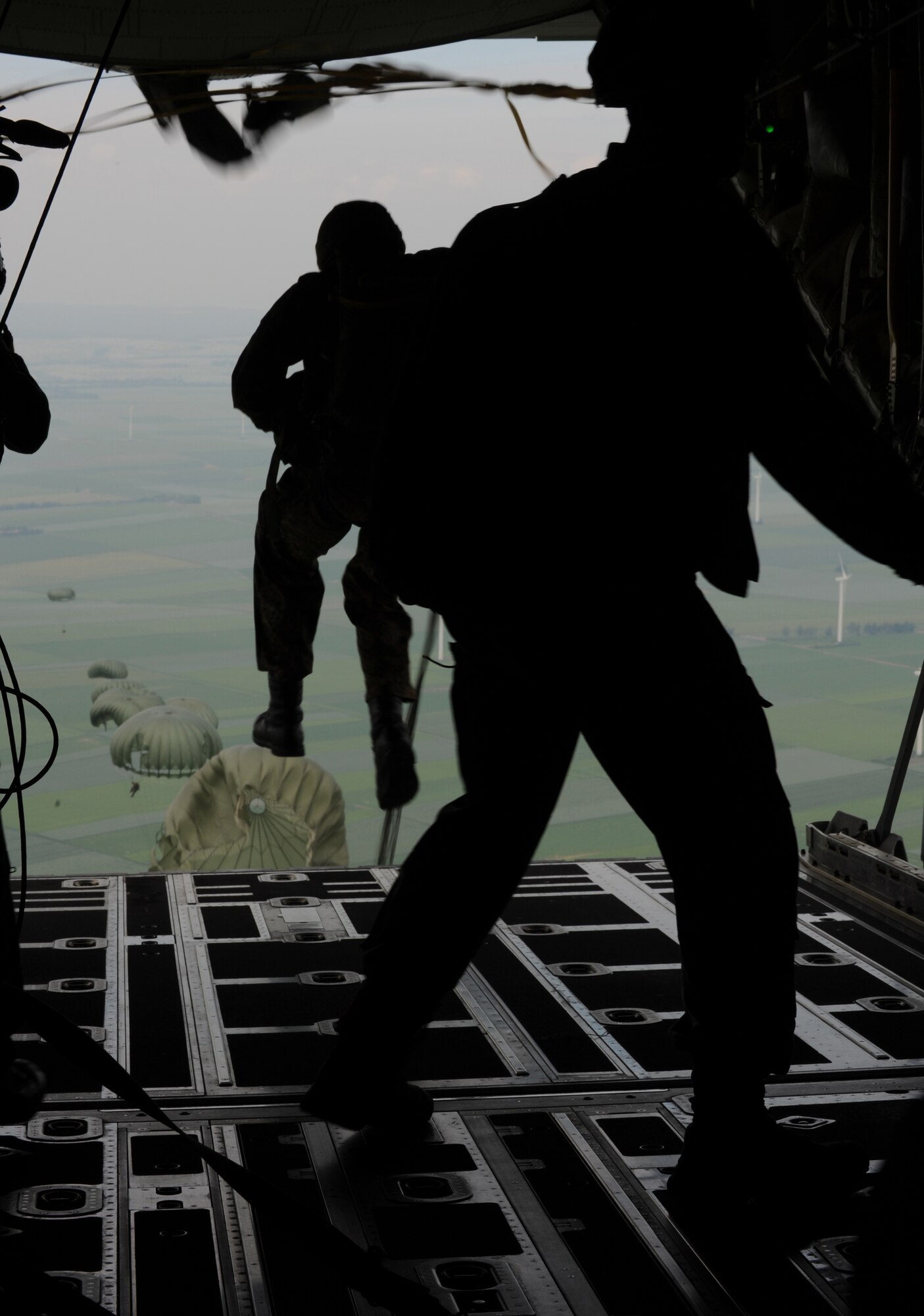 Airborne troops jump from a C-130J as part of the NATO jump week, Alzey, Germany, June 15, 2010. Five NATO countries participated in the annual event to support one of United States Air Forces in Europe's top priorities; building partnerships. (U.S. Air Force photo by Airman 1st Class Caleb Pierce)