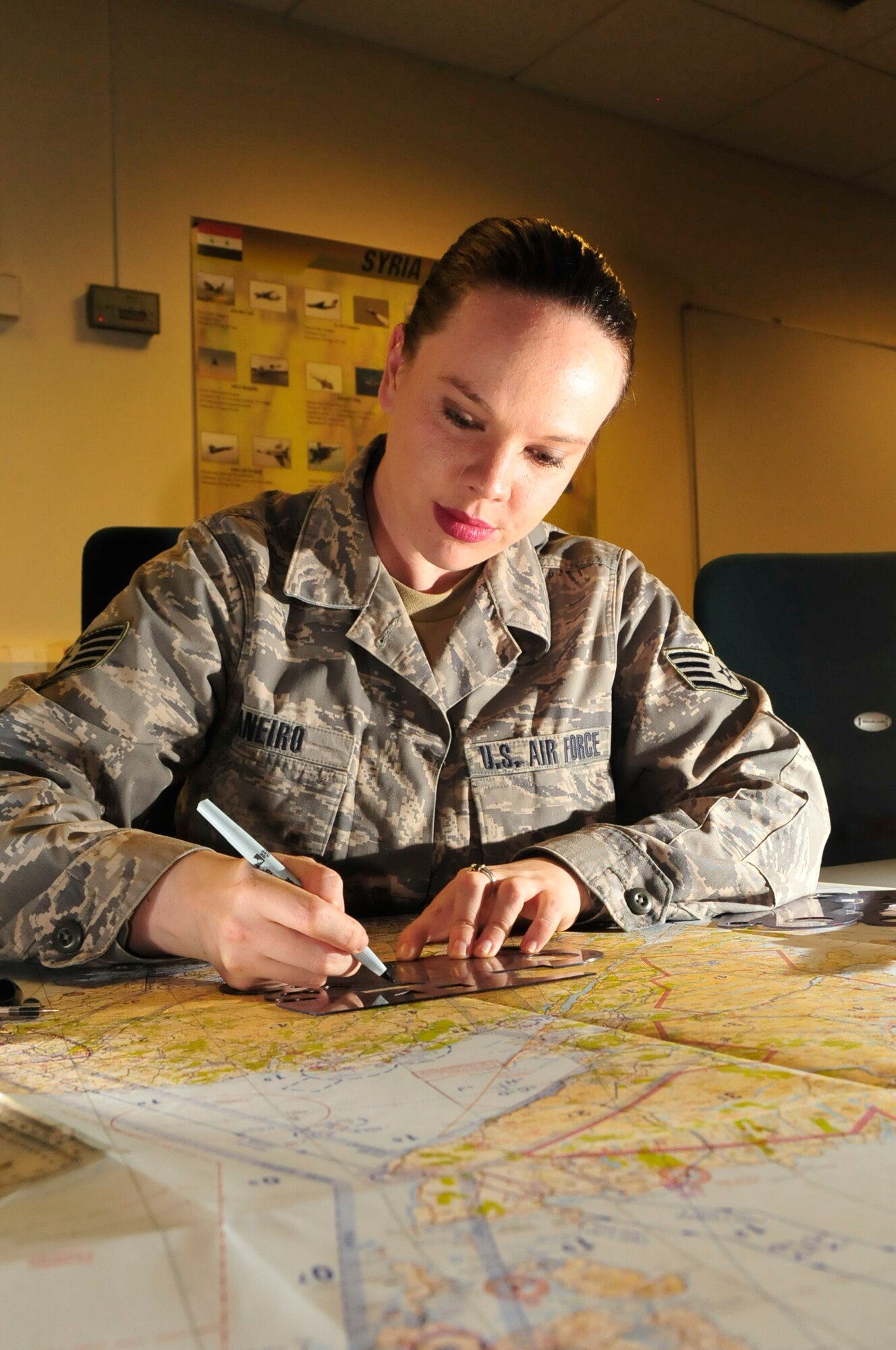 Staff Sgt. Alexandra Maneiro-Martinho, 48th Operations Group NCO in-charge of standards and evaluation, plots coordinates on a map June 16 at RAF Lakenheath, England. Sergeant Maneiro-Martinho was nominated for a Liberty Spotlight because she portrays the core value of Service Before Self. (U.S. Air Force photo/Airman 1st Class Eboni Knox)