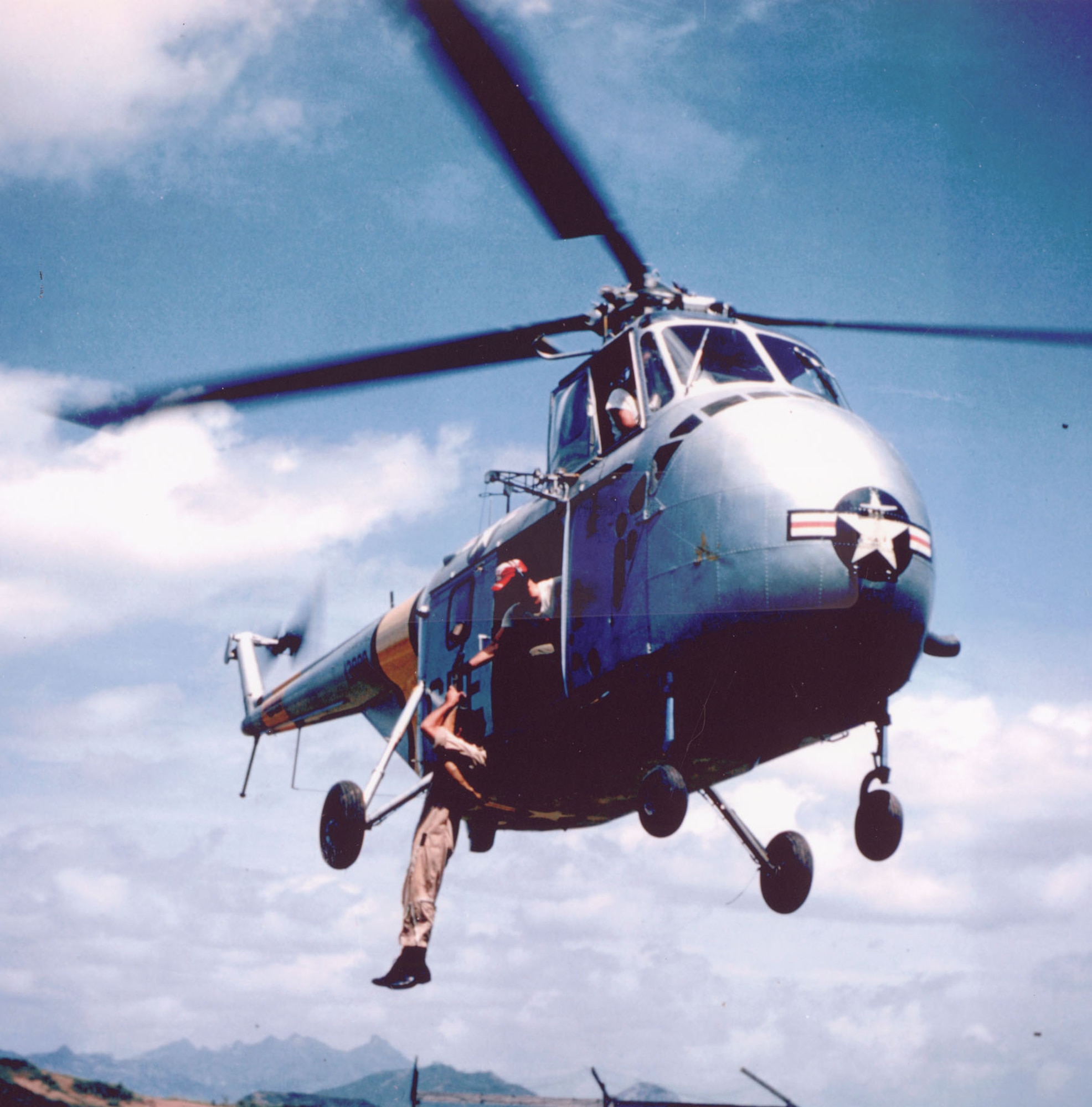 With the increasing use of helicopters, the USAF developed new rescue techniques including using hydraulic winches. Here, an Airman is hoisted aboard a hovering SH-19. (U.S. Air Force photo)
