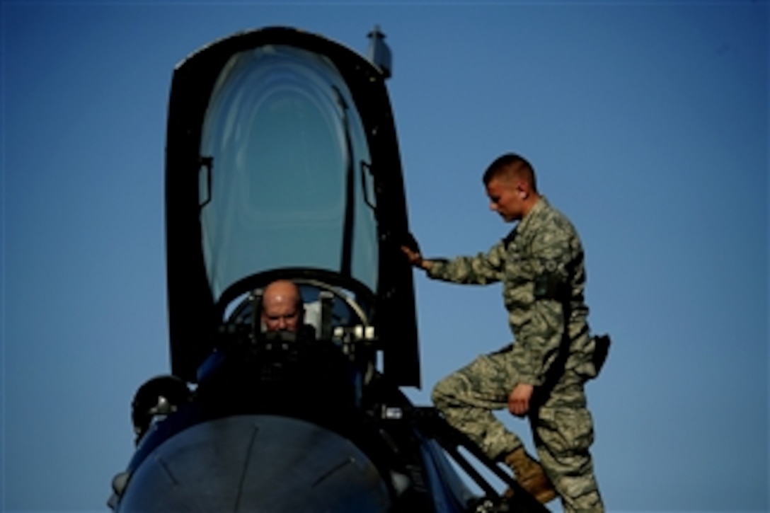 U.S. Air Force Senior Airman Aleksandr Dolgikh (right) conducts preflight checks on an F-16 Aggressor aircraft with Lt. Col. Andrew Hansen at Eielson Air Force Base, Alaska, prior to a sortie in support of Red Flag ? Alaska 10-03 on June 14, 2010.  More than 1,300 airmen from the United States, Japan and Italy are participating in the aerial training exercise.  Dolgikh is a crew chief from the 354th Aircraft Maintenance Squadron and Hansen is the commander of the 18th Aggressor Squadron.  
