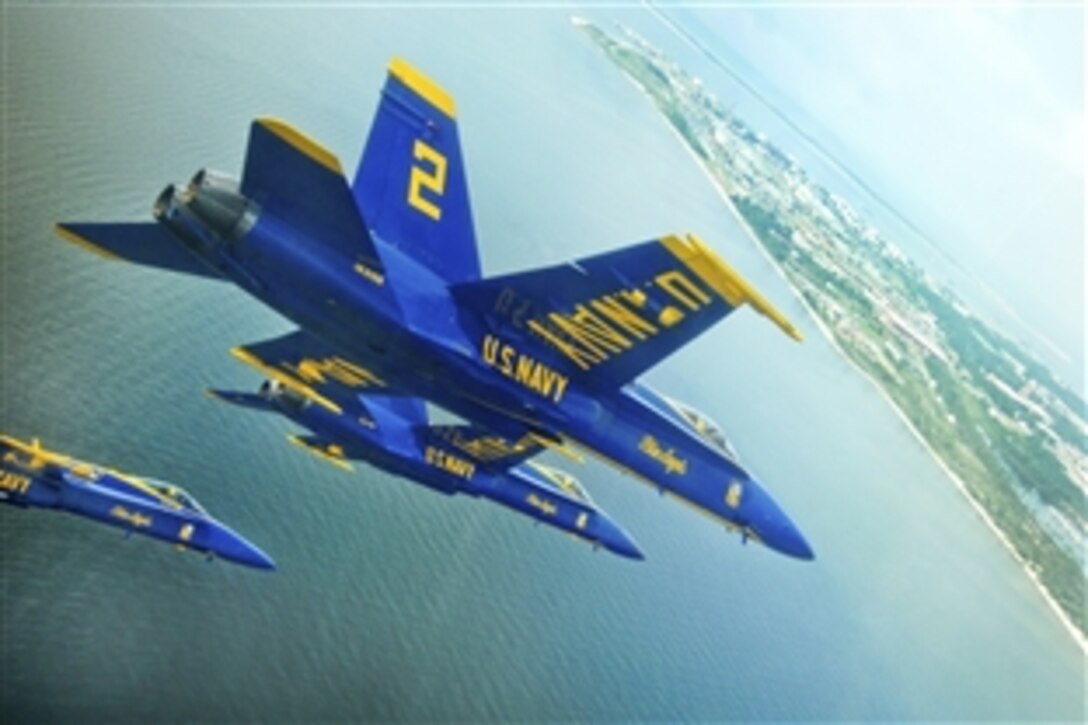 The U.S. Navy flight demonstration squadron, the Blue Angels, align behind the crowd line during a practice demonstration over Pensacola, Fla., June 16, 2010. The team practices over the air station two days a week throughout the show season.