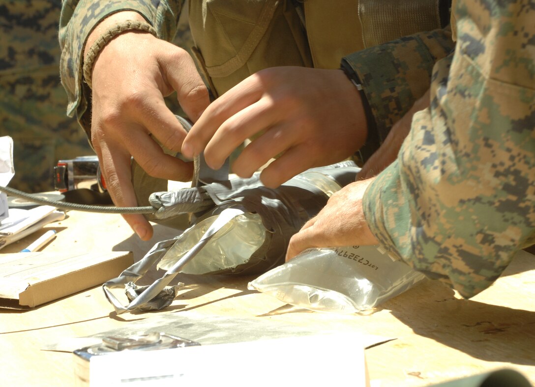 Marines from Combat Engineer Platoon, Marine Wing Support Squadron 473 build explosive charges at Hawthorne Army Weapons Depot, Nev. June 17 during exercise Javelin Thrust 2010.  The Marines practiced urban breaching with different types of precision charges several times to gain confidence in working with demolitions.