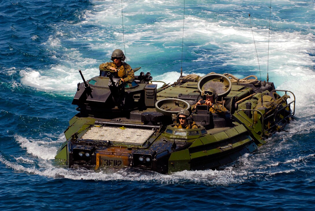 Marines from the 1st Battalion, 4th Marine Division, return to the amphibious transport dock ship USS Dubuque (LPD 8) in an amphibious assault vehicle after training with Indonesian Marines during Marine Exercise 2010 on June 22, 2010.  Marine Exercise is designed to provide training to the Indonesian military and build relationships that help maintain regional stability.