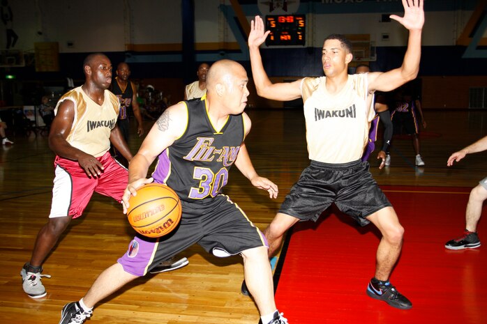 Jayson Tangco, guard for Fil-Am, rushes around D.J. Wright, guard for the Ready Group, during a semifinal basketball game at the IronWorks Gym here June 17. The final score read 19-18 in favor of Fil-Am when the game was called with just 46.2 seconds left in the first half.