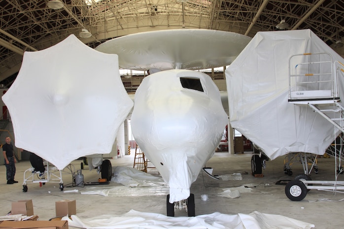 An E-2 Hawkeye prepares to finish the final stage of the three-part shipping process to Naval Air Facility North Island, San Diego. The  plane is first wrapped in shrink-wrap, provided by Hipp Marine Services Inc. During this process, the plane is completely wrapped and sealed to prevent the plane from rust or damage during its voyage at sea. The complete wrapping process was a three-day evolution.