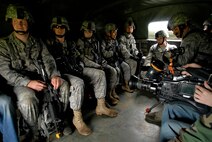 Members of the 115th Security Forces Squadron wait to depart for training scenario at Volk Field Combat Readiness Training Center, Wis., June 14, 2010. Security Forces conducted a search of a mock village for a person of interest, while preserving the peace in a hostile environment. (U.S. Air Force photo by Tech Sgt. Ashley Bell)