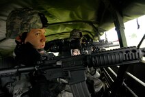 Staff Sgt. Christian Bennett, 115th Security Forces Squadron Fire Team Leader, watches for possible hostiles during a convoy operation at Volk Field Combat Readiness Training Center, Wis., June 14, 2010. The 115th SFS participated in a week long combat exercise as part of yearly training. (U.S. Air Force photo by Tech Sgt. Ashley Bell)