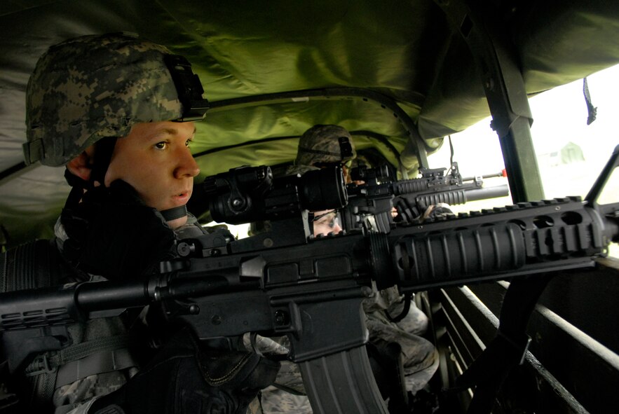 Staff Sgt. Christian Bennett, 115th Security Forces Squadron Fire Team Leader, watches for possible hostiles during a convoy operation at Volk Field Combat Readiness Training Center, Wis., June 14, 2010. The 115th SFS participated in a week long combat exercise as part of yearly training. (U.S. Air Force photo by Tech Sgt. Ashley Bell)