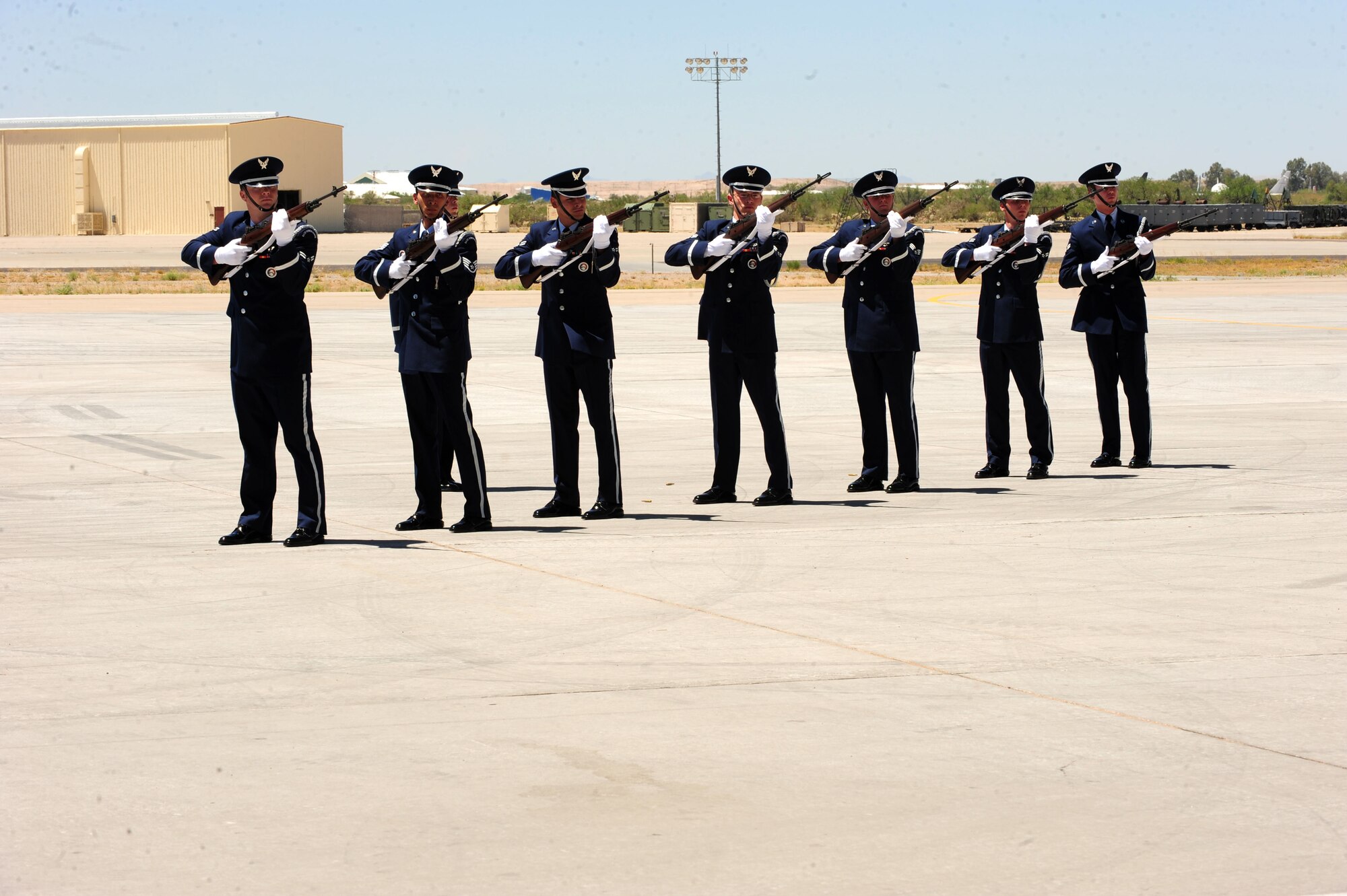 Airmen from the Davis-Monthan Honor Guard perform the 21-gun salute during the memorial service for Tech. Sgt. Michael Flores and Senior Airman Benjamin White, both pararescuemen from the 48th Rescue Squadron here June 17. Sergeant Flores and Airman White were among the four Airmen killed in a helicopter crash on June 9 in southeastern Afghanistan while on deployment in support of Operation Enduring Freedom. (U.S. Air Force photo/Airman 1st Class Jerilyn Quintanilla)