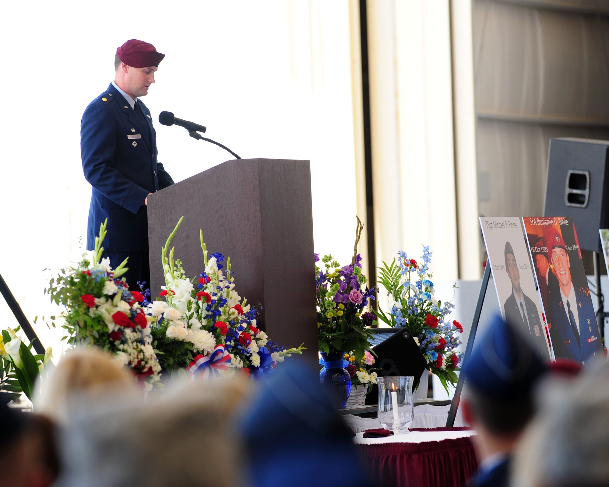 Maj. Jason Pifer, 48th Rescue Squadron commander, speaks at the memorial service for Tech. Sgt. Michael Flores and Senior Airman Benjamin White, both pararescuemen from the 48th RQS, here June 17. Sergeant Flores and Airman White were among the four Airmen killed after their helicopter crashed June 9 in southeastern Afghanistan while on a deployment in support of Operation Enduring Freedom. (U.S. Air Force photo/Airman 1st Class Jerilyn Quintanilla)