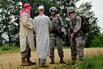 Members of the 115th Fighter Wing Security Forces Squadron attempt to gain intelligence information from airman dressed as bystanders during Security Forces counter insurgency (COIN) exercise at Volk Field Combat Readiness Training Center , June 14, 2010.  Members of Services Flight and Security Forces Squadron were assigned houses, wore garments familiar in the Middle East, and were instructed to engage security forces during their patrol through the simulated village.  (U.S. Air Force photo by Staff Sgt. Christen Bloomfield/Released)