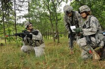 Airmen from the 115th Security Forces Squadron, pause to discuss the direction of their next destination point during their land navigation training at Volk Field CRTC, Wis., June 13, 2010.  Airmen participating in teams are tasked to find their way to a set of destination points through heavily wooded areas, with nothing but a compass and a set of coordination points while avoiding enemy forces. (U.S. Air Force photo by Staff Sgt. Christen Bloomfield)