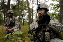 Airman 1st Class Thao Moua, right, and Staff Sgt. Jeff Williams, both members of the 115th Security Forces Squadron, take part in a land navigation exercise at Volk Field Combat Readiness Training Center, Wis., June 13, 2010. The 115th SFS participated in a week long combat exercise as part of yearly training for members.  (U.S. Air Force photo by Tech Sgt. Ashley Bell)

