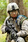 Airman 1st Class Thao Moua, 115th Security Forces Apprentice, scans the tree line for enemy combatants during a Security Forces land navigation exercise, Volk Field Combat Readiness Training Center, Wis., June 13, 2010. The 115th SFS participated in a week long combat exercise as part of yearly training for members.  (U.S. Air Force photo by Tech Sgt. Ashley Bell)