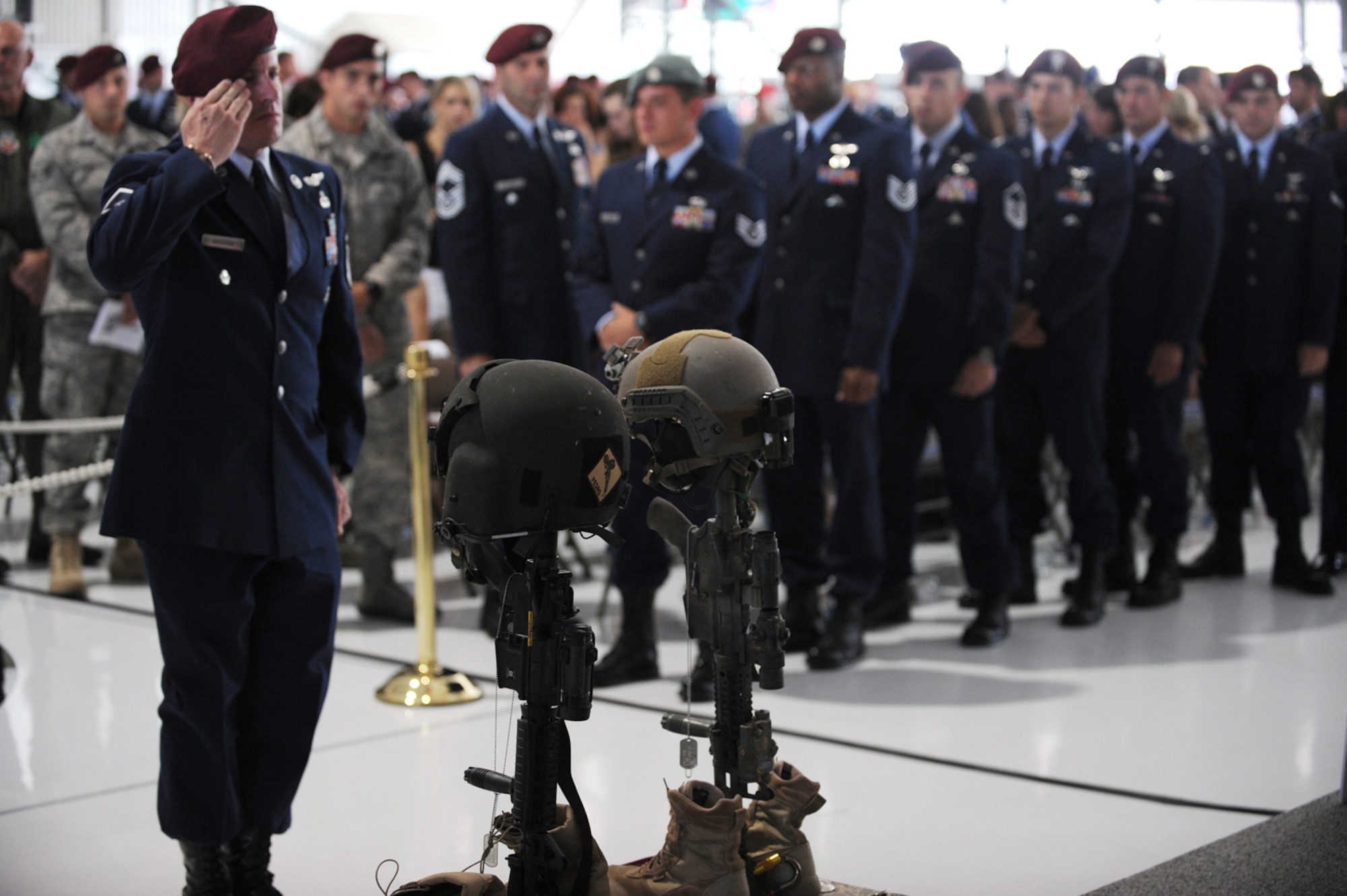 NELLIS AIR FORCE BASE, Nev. -- A U.S. Air Force pararescueman pays final respects to 1st Lt. Joel Gentz, 25, a combat rescue officer assigned to the 58th Rescue Squadron; and Staff Sgt. David Smith, 26, a helicopter flight engineer assigned to the 66th Rescue Squadron during a memorial ceremony at Nellis Air Force Base June 18.  The two were among four Airmen killed and three wounded when an HH-60G Pave Hawk helicopter crashed during a medevac mission in southeastern Afghanistan June 9. (U.S. Air Force photo by Master Sgt. Kevin Gruenwald) released





