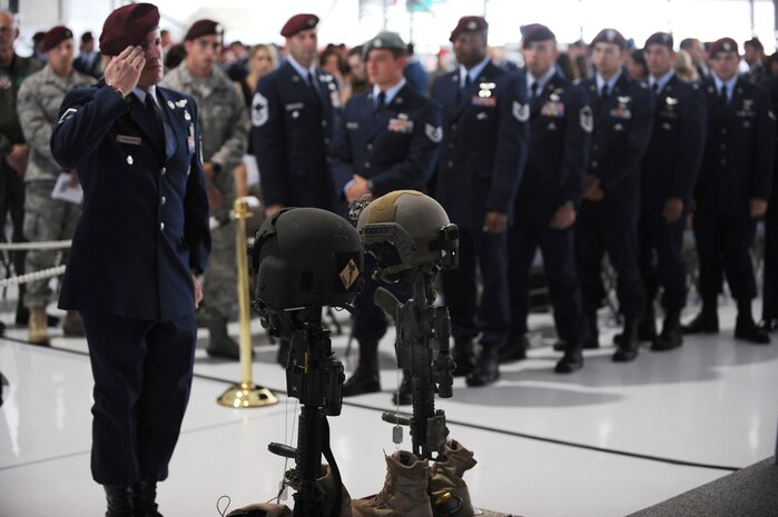 NELLIS AIR FORCE BASE, Nev. -- A U.S. Air Force pararescueman pays final respects to 1st Lt. Joel Gentz, 25, a combat rescue officer assigned to the 58th Rescue Squadron; and Staff Sgt. David Smith, 26, a helicopter flight engineer assigned to the 66th Rescue Squadron during a memorial ceremony at Nellis Air Force Base June 18.  The two were among four Airmen killed and three wounded when an HH-60G Pave Hawk helicopter crashed during a medevac mission in southeastern Afghanistan June 9. (U.S. Air Force photo by Master Sgt. Kevin Gruenwald) released




