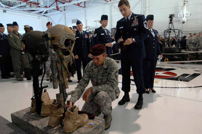 NELLIS AIR FORCE BASE, Nev. - A U.S. Air Force pararescueman pays final respects to 1st Lt. Joel Gentz, 25, a combat rescue officer assigned to the 58th Rescue Squadron; and Staff Sgt. David Smith, 26, a helicopter flight engineer assigned to the 66th Rescue Squadron during a memorial ceremony at Nellis Air Force Base June 18.  The two were among four Airmen killed and three wounded when an HH-60G Pave Hawk helicopter crashed during a medevac mission in southeastern Afghanistan June 9. (U.S. Air Force photo by Master Sgt. Kevin Gruenwald)
 




