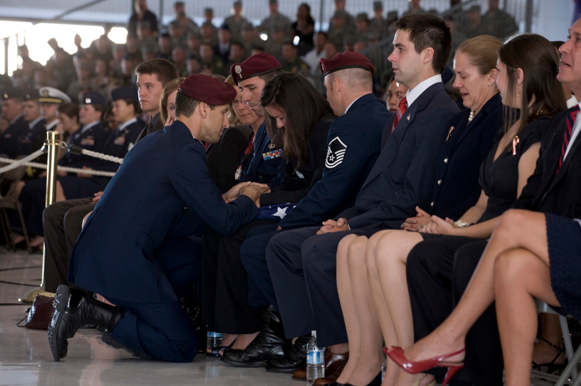 NELLIS AIR FORCE BASE, Nev. -- Lt. Col. Andrew Reisenweber, 58th Rescue Squadron Commander, hands a funeral flag to Mrs. Kathryn Gentz, wife of 1st Lt. Joel Gentz, 25, a combat rescue officer assigned to the 58th Rescue Squadron during a memorial ceremony at Nellis Air Force Base June 18. 1st Lt.Gentz was among four Airmen killed and three wounded when his HH-60G Pave Hawk helicopter crashed during a medevac mission in southeastern Afghanistan June 9. (U.S. Air Force Photo / Airman 1st Class Jamie Nicley)