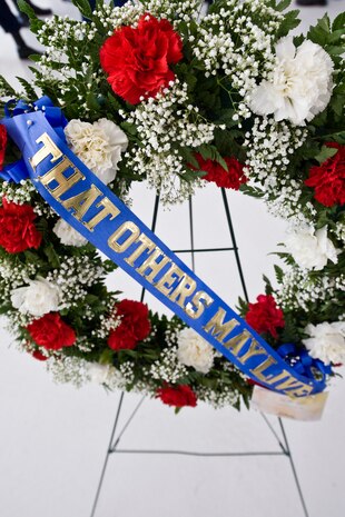 NELLIS AIR FORCE BASE, Nev. -- A wreath that embodies the rescue community motto "THAT OTHERS MAY LIVE"  is displayed at 1st Lt. Joel Gentz, 25, a combat rescue officer assigned to the 58th Rescue Squadron; and Staff Sgt. David Smith, 26, a helicopter flight engineer assigned to the 66th Rescue Squadron memorial ceremony at Nellis Air Force Base June 18.  The two were among four Airmen killed and three wounded when an HH-60G Pave Hawk helicopter crashed during a medevac mission in southeastern Afghanistan June 9. (U.S. Air Force Photo / Lawrence Crespo)