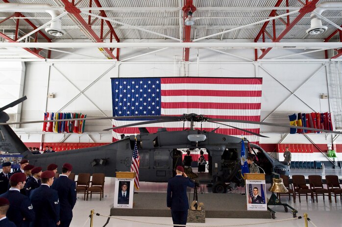 NELLIS AIR FORCE BASE, Nev. -- A pararescue airman renders a salute  1st Lt. Joel Gentz, 25, a combat rescue officer assigned to the 58th Rescue Squadron; and Staff Sgt. David Smith, 26, a helicopter flight engineer assigned to the 66th Rescue Squadron during a memorial ceremony at Nellis Air Force Base June 18.  The two were among four Airmen killed and three wounded when an HH-60G Pave Hawk helicopter crashed during a medevac mission in southeastern Afghanistan June 9.(U.S. Air Force Photo / Lawrence Crespo)