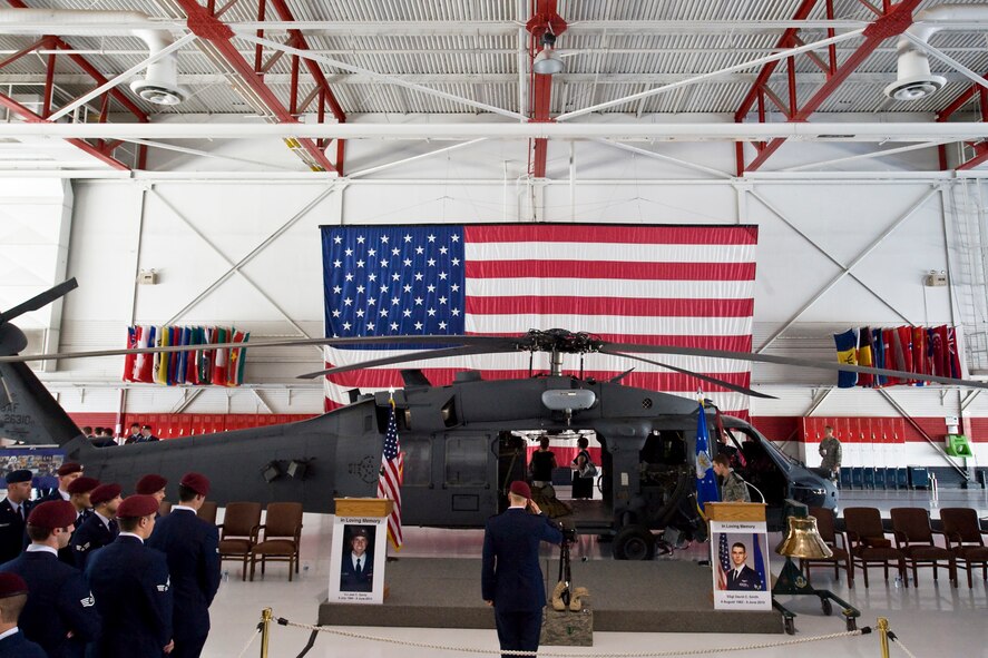 NELLIS AIR FORCE BASE, Nev. -- A pararescue airman renders a salute  1st Lt. Joel Gentz, 25, a combat rescue officer assigned to the 58th Rescue Squadron; and Staff Sgt. David Smith, 26, a helicopter flight engineer assigned to the 66th Rescue Squadron during a memorial ceremony at Nellis Air Force Base June 18.  The two were among four Airmen killed and three wounded when an HH-60G Pave Hawk helicopter crashed during a medevac mission in southeastern Afghanistan June 9.(U.S. Air Force Photo / Lawrence Crespo)