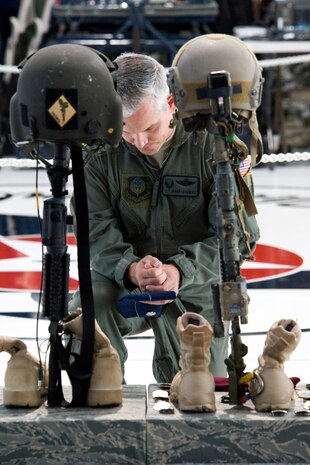 NELLIS AIR FORCE BASE, Nev. -- Lt. Col. Javier Casanova, Air Force Special Operations Command, pays his final respects to 1st Lt. Joel Gentz, 25, a combat rescue officer assigned to the 58th Rescue Squadron; and Staff Sgt. David Smith, 26, a helicopter flight engineer assigned to the 66th Rescue Squadron during a memorial ceremony at Nellis Air Force Base June 18.  The two were among four Airmen killed and three wounded when an HH-60G Pave Hawk helicopter crashed during a medevac mission in southeastern Afghanistan June 9. (U.S. Air Force Photo / Lawrence Crespo)