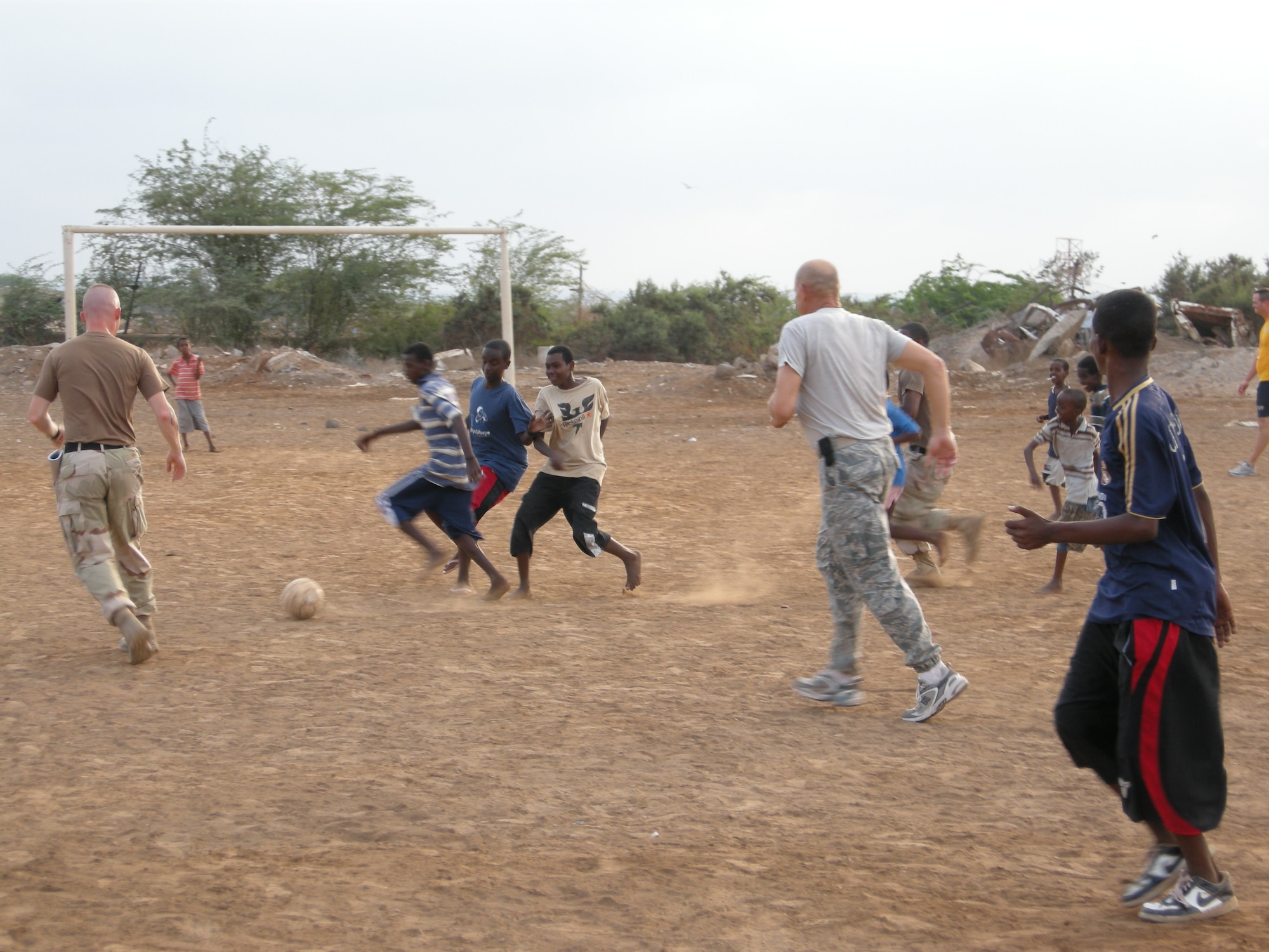 MSgt David Zibell playing soccer in Uganda with local children from the boy’s orphage.