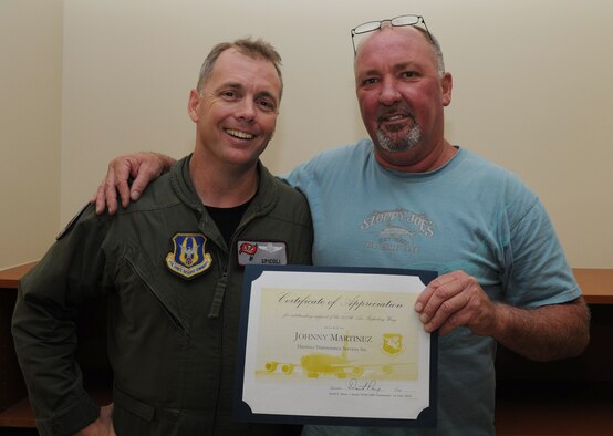 Johnny Martinez (right) shows off his Certificate of Appreciation for being a supportive employer while standing next to his part-time employee Master Sgt. Johnny Pullen in the 927th Air Refueling Wing Headquarters at MacDill Air Force Base, Fla. June 18, 2010. Pullen, a boom operator with the 63rd Air Refueling Squadron, nominated Martinez for the award, which was presented as part of an Employer Support of the Guard and Reserve bosslift. (U.S. Air Force photo by Senior Airman Anna-Marie Wyant)