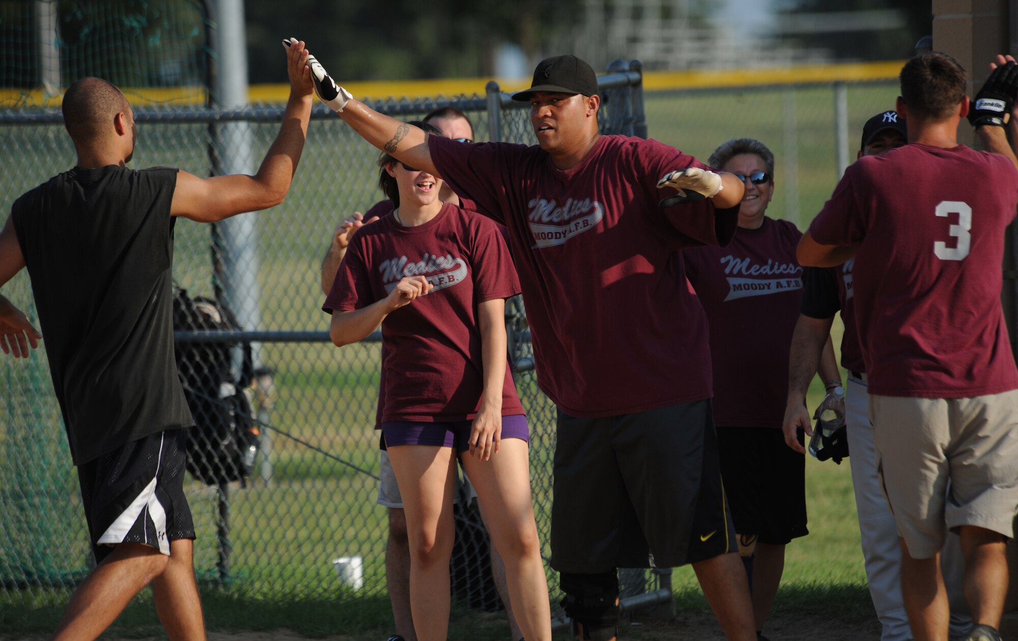 MOODY AIR FORCE BASE, Ga. -- Master Sgt. Joseph Sutton, 94th Air Wing recruiter, congratulates his team after a great inning during the base softball championship game here June 18. Sergeant Sutton played first baseman for the 23rd Medical Group team. (U.S. Air Force photo by Airman 1st Class Benjamin Wiseman/RELEASED)