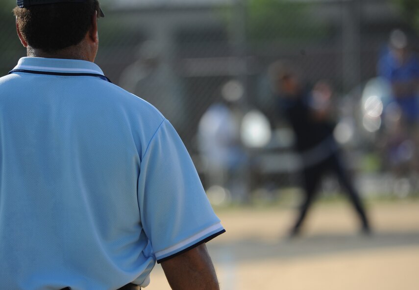 MOODY AIR FORCE BASE, Ga. -- Umpire Bob Cosby stares down the first base line as a batter takes a swing during the base softball championship game here June 18. Mr. Cosby is an official American Softball Association umpire. (U.S. Air force photo by Airman 1st Class Benjamin Wiseman/RELEASED)
