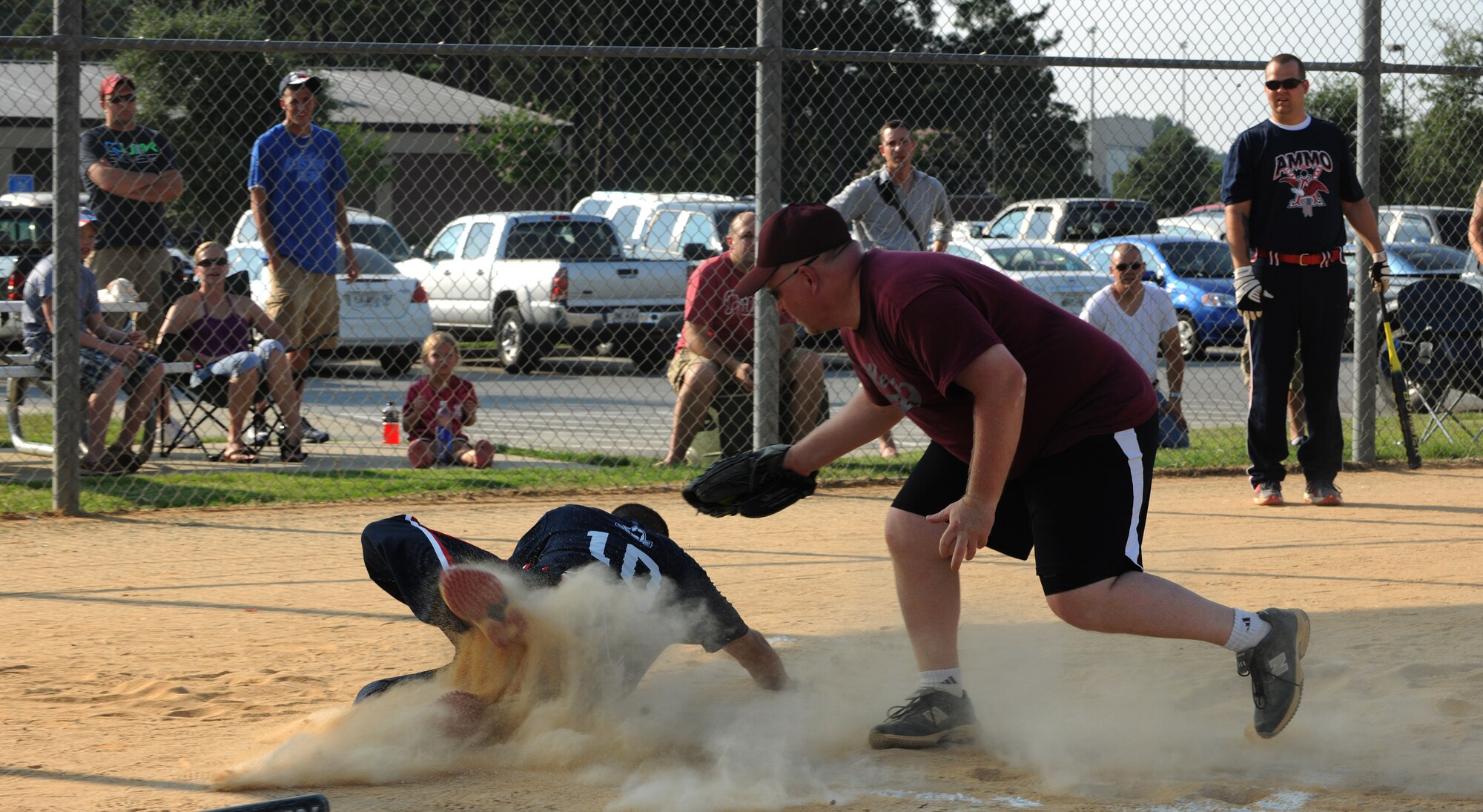 MOODY AIR FORCE BASE, Ga. -- Tech. Sgt. Brian Sadler, 23rd Equipment Maintenance Squadron munitions flight controller, slides under the tag of Randy Fox, 23rd Medical Group team member, during the base softball championship game here June 18. The umpire determined that Sergeant Sadler was safe. (U.S. Air Force photo by Airman 1st Class Benjamin Wiseman/RELEASED)