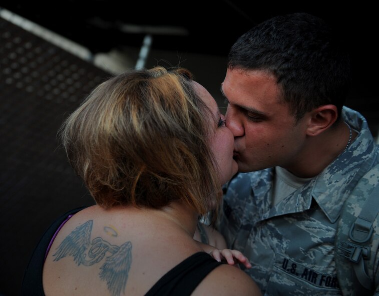 MOODY AIR FORCE BASE, Ga. -- Airman 1st Class Samuel Wetzel, 23rd Equipment Maintenance Squadron equipment maintenance crew member, is welcomed home by his wife Ashley and daughter Peyton here June 17. (U.S. Air Force photo by Staff Sgt. Gina Chiaverotti-Paige/RELEASED)