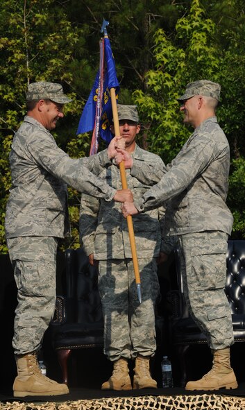 MOODY AIR FORCE BASE, Ga. -- Col. John Horner, 93rd Air Ground Operations Wing commander, presents the guidon to Col. Randall Richert, 820th Security Forces Group incoming commander, during the 820th SFG change of command ceremony here June 18. The transfer of a guidon is a tradition at every change of command ceremony. (U.S. Air Force photo by Airman 1st Class Benjamin Wiseman/RELEASED)