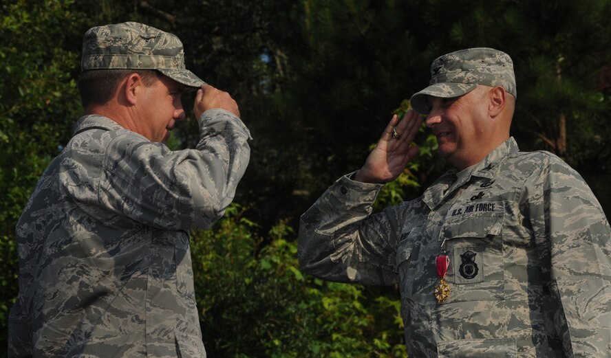 MOODY AIR FORCE BASE, Ga. -- Col. John Horner, 93rd Air Ground Operations Wing commander, presents the Legion of Merit Medal to Col. Donald Derry, 820th Security Forces Group outgoing commander, during the 820th SFG change of command ceremony here June 18. Colonel Derry received the medal for his outstanding, superior leadership and person endeavor during his command. (U.S. Air Force photo by Airman 1st Class Benjamin Wiseman/RELEASED)