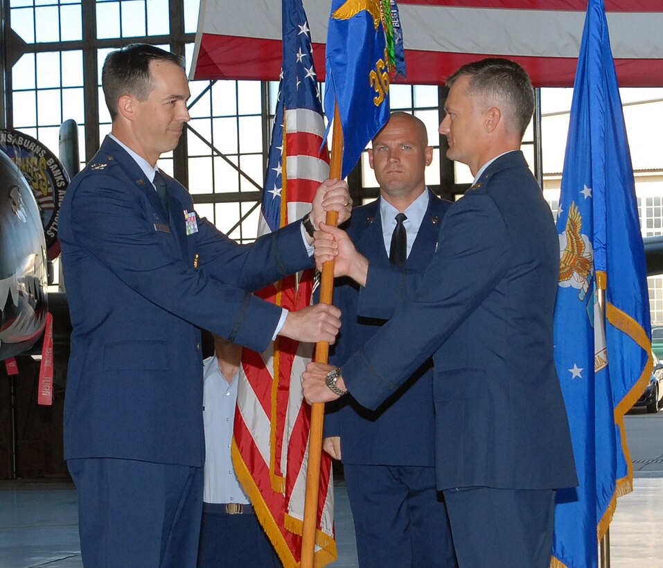 Maj. Reggie Christianson (right) assumes command of the 362nd Training Squadron from Col. Shawn Harrison (left), 82nd Training Group commander, during the ceremony held in Hangar 1090 at Sheppard Air Force Base, Texas, June 17, 2010.  Major Christianson was previously assigned as commander of the 100th Maintenance Operations Squadron at Royal Air Force Mildenhall, England.  (U.S. Air Force photo/Lou Anne Sledge)