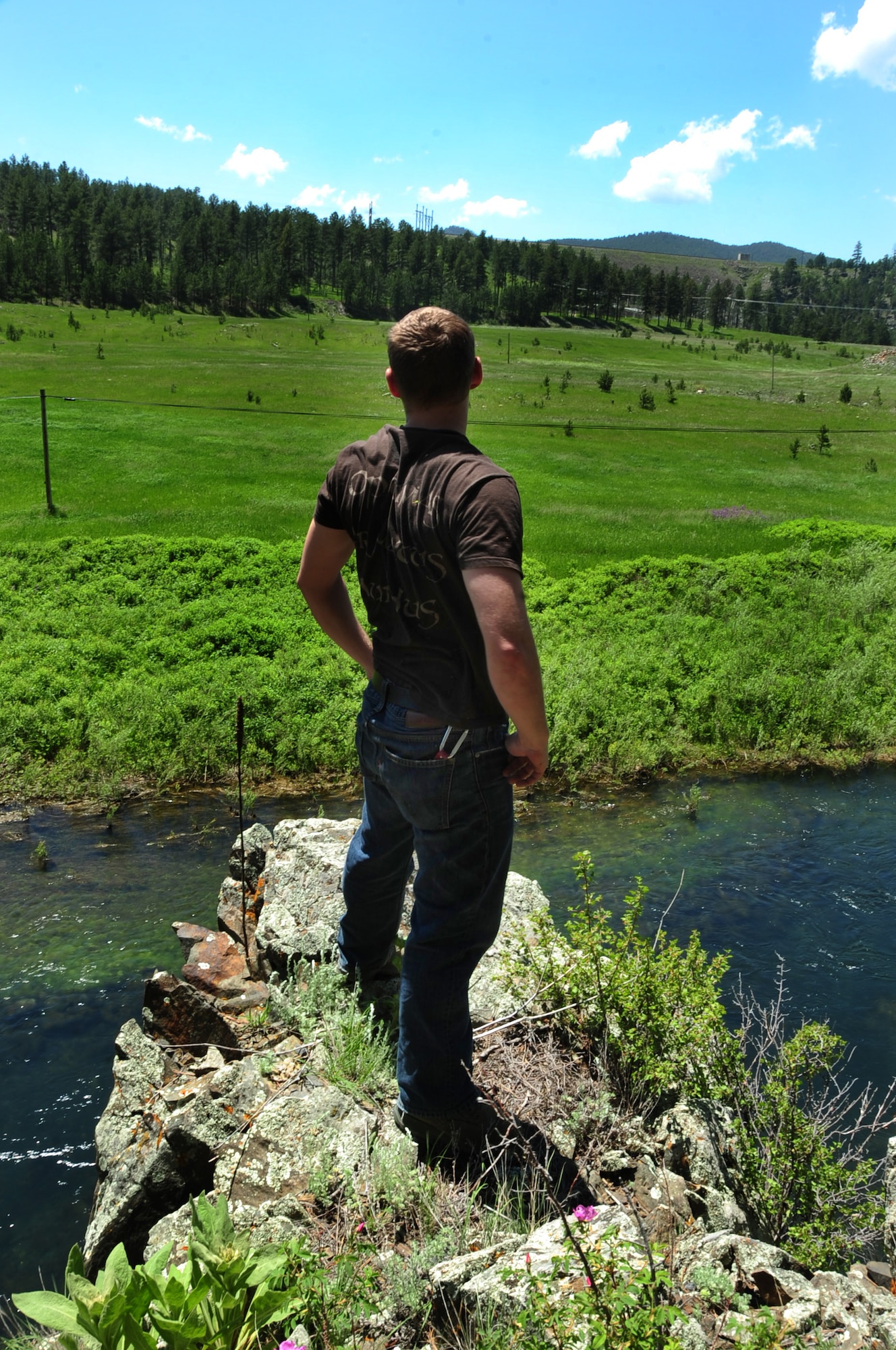 ELLSWORTH AIR FORCE BASE, S.D. -- Airman 1st Class Mitchell Carrell, 28th Civil Engineer Squadron firefighter, takes a break after climbing an out-crop of rocks in the summer heat at Rapid Creek Trail Head, Rapid City, S.D., 16 June.  While working in the summer heat it’s important to periodically take breaks and drink plenty of water. (U.S. Air Force photo/Airman 1st Class Anthony Sanchelli)
