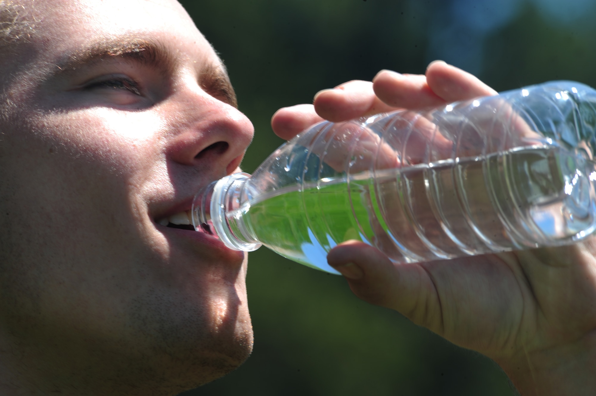 ELLSWORTH AIR FORCE BASE, S.D. -- Airman 1st Class Mitchell Carrell, 28th Civil Engineer Squadron firefighter, drinks water after hiking in the sun to keep hydrated at Rapid Creek Trail Head, Rapid City, S.D., 16 June.  While working outside in the heat, drinking water will assist in regulating the body temperature, preventing overheating. (U.S. Air Force photo/Airman 1st Class Anthony Sanchelli)
