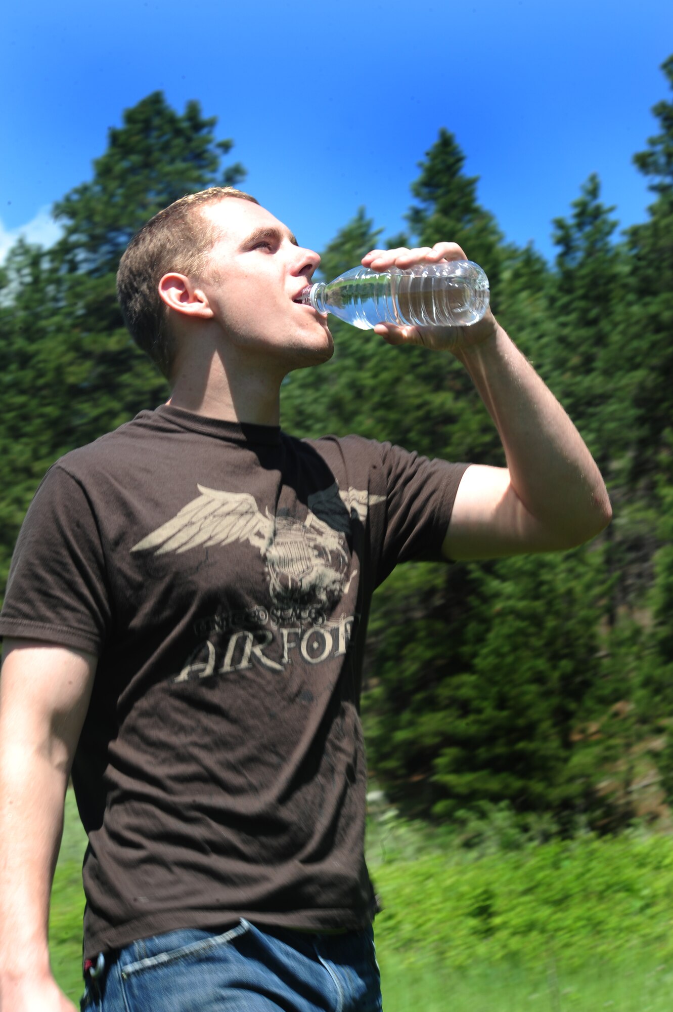 ELLSWORTH AIR FORCE BASE, S.D. -- Airman 1st Class Mitchell Carrell, 28th Civil Engineer Squadron firefighter, drinks water after hiking in the sun to keep hydrated at Rapid Creek Trail Head, Rapid City, S.D., June 16.  It’s important to drink water while doing activities in the sun to keep the body from overheating. (U.S. Air Force photo/Airman 1st Class Anthony Sanchelli)
