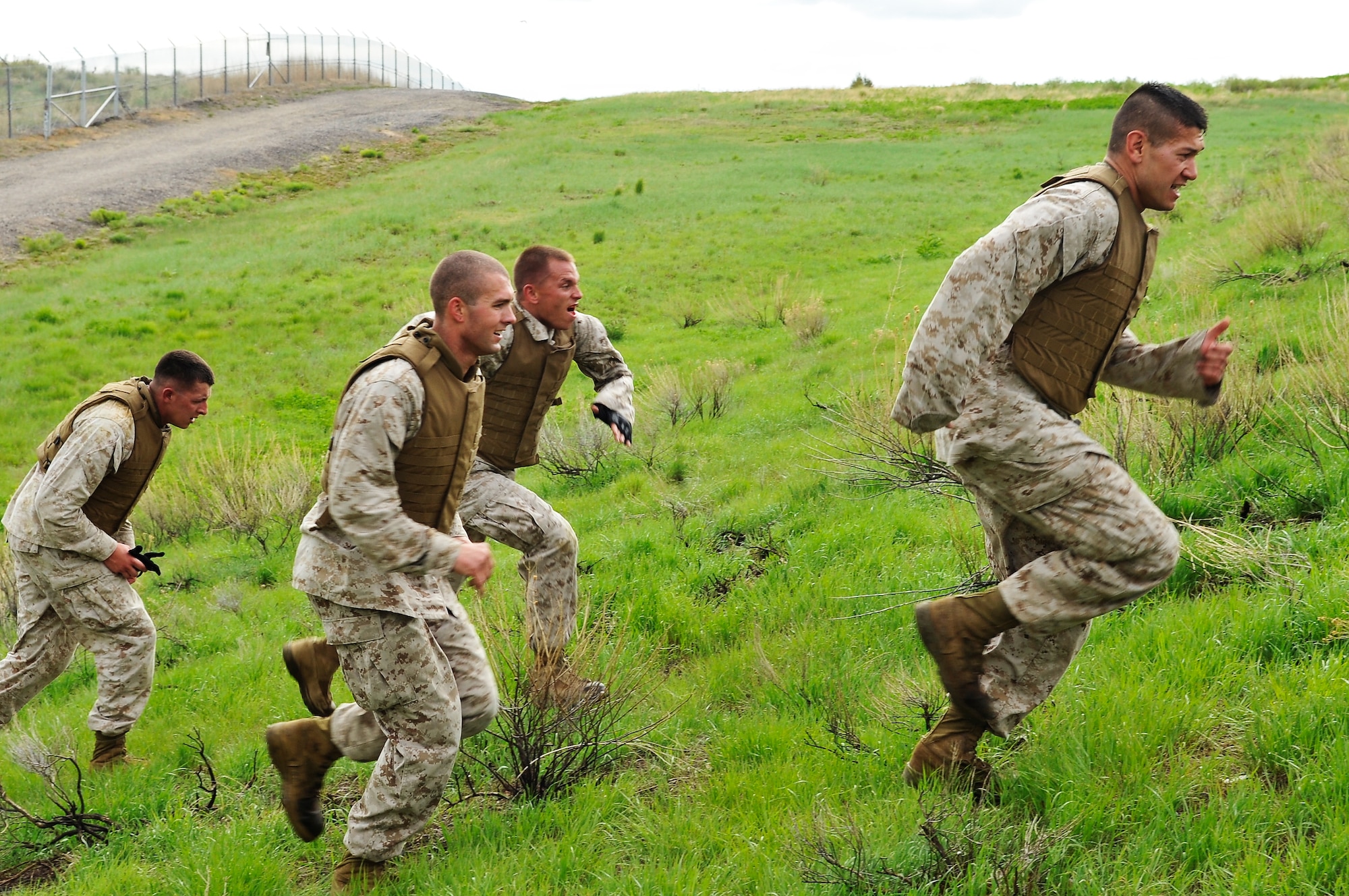 BUCKLEY AIR FORCE BASE, Colo. --Macs 23 marines Sgt Randall Blankenship, Cpl Charles Bays, Sgt Joshua Tucker,Sgt. Dale S Steinecke ascends up a hill. After completion of the MCMAP course the students are able to gain a different color belt according to there skill level.(U.S Air Force photo by Airman 1st Class Paul Labbe) 
