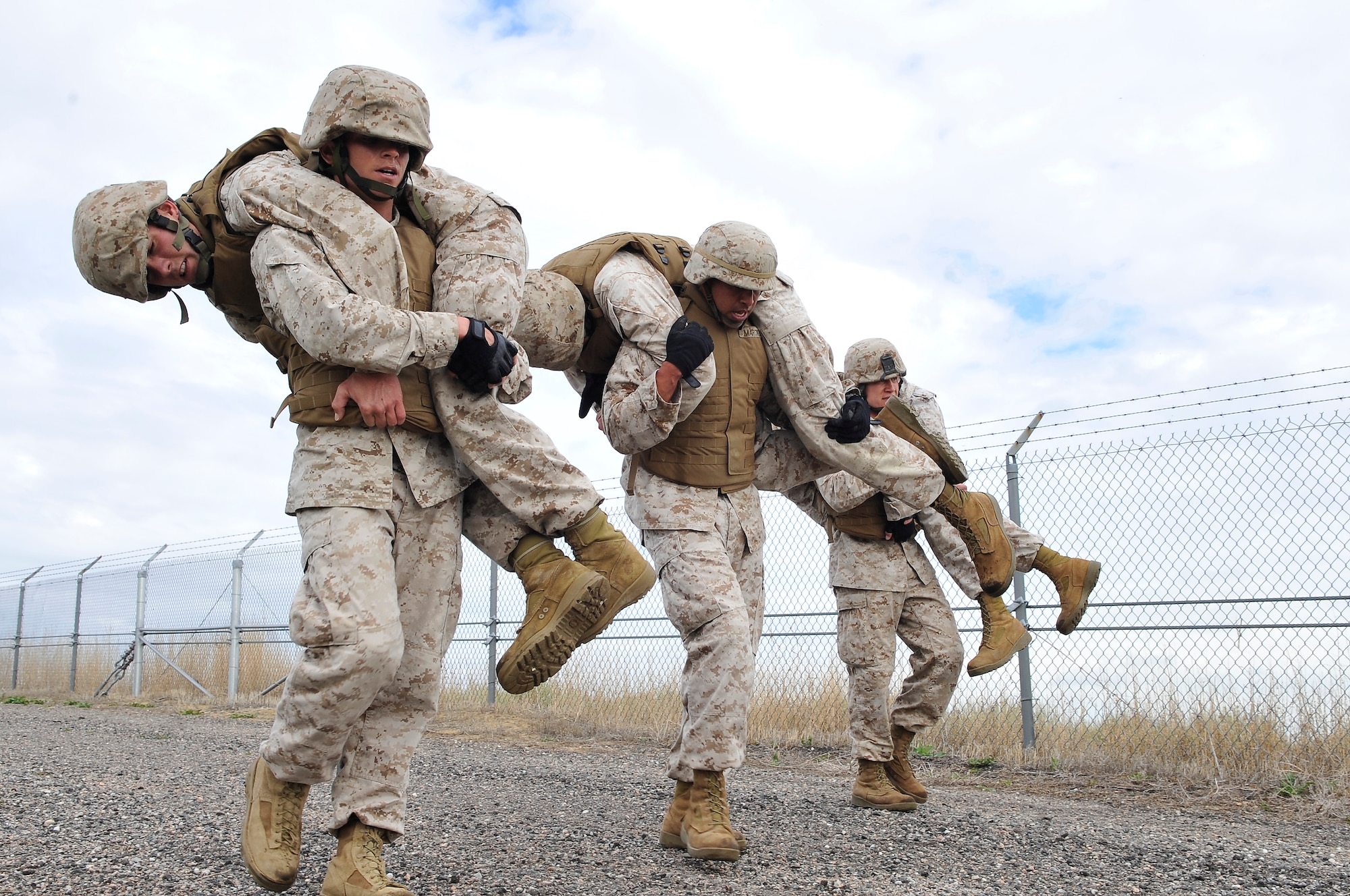 BUCKLEY AIR FORCE BASE, Colo. --Macs-23 Marines(left to right) Sgt Randall Blankenship, SSgt Albert Martinez, Cpl Charles Bays carries fellow Marines (left to right) Sgt. Dale S Steinecke, Cpl Trent Wilcox , Sgt Joshua Tucker as part of there Combat Skills training.Marine members take a three week Marine Corps Martial Arts Program course.(U.S Air Force photo by Airman 1st Class Paul Labbe) 