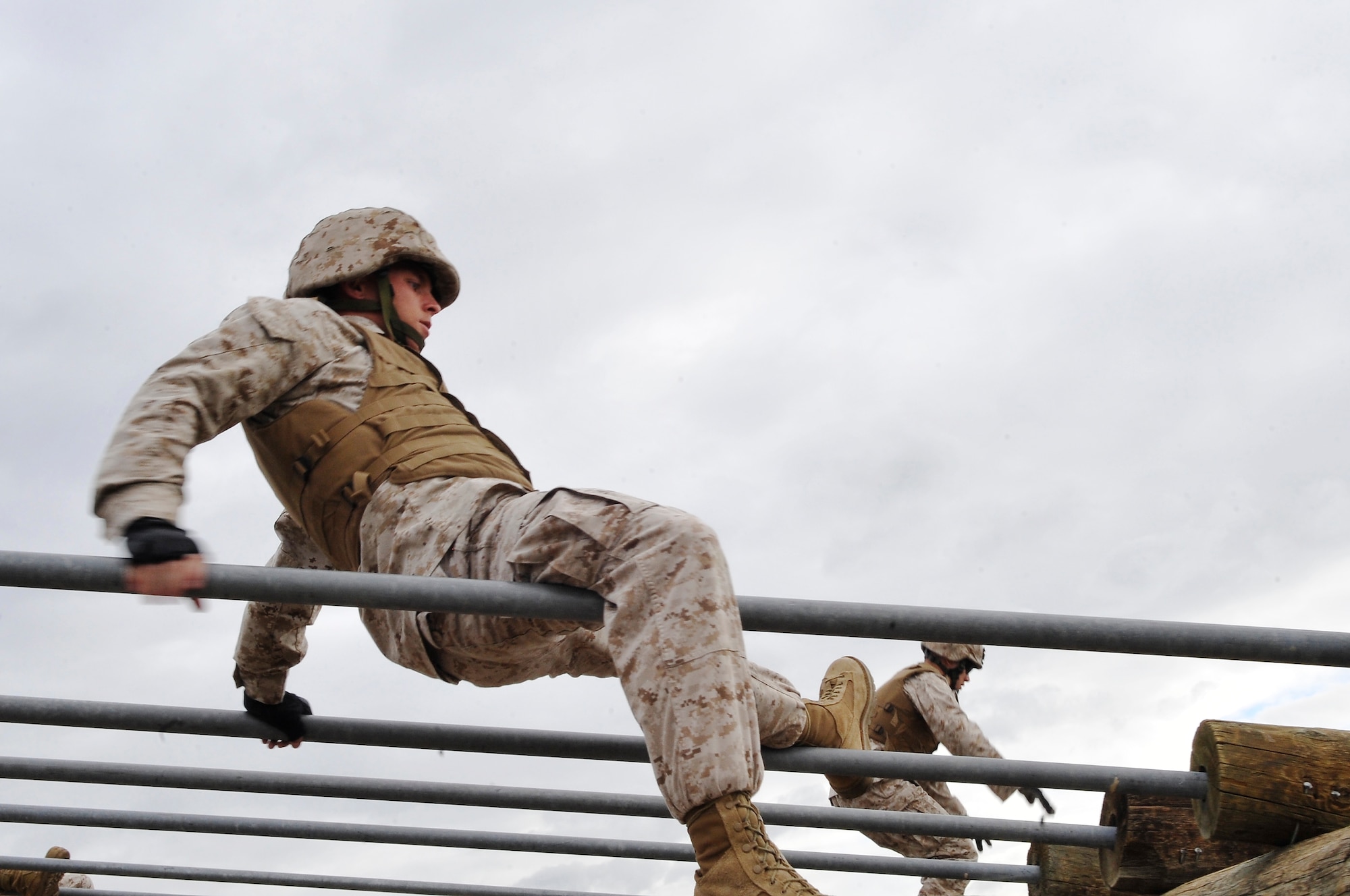 BUCKLEY AIR FORCE BASE, Colo. --
Sgt Randall  Blankenship,Macs-23 crosses   a bar obstacle. The course test students physically and also mentally.(U.S Air Force photo by Airman 1st Class Paul Labbe) 