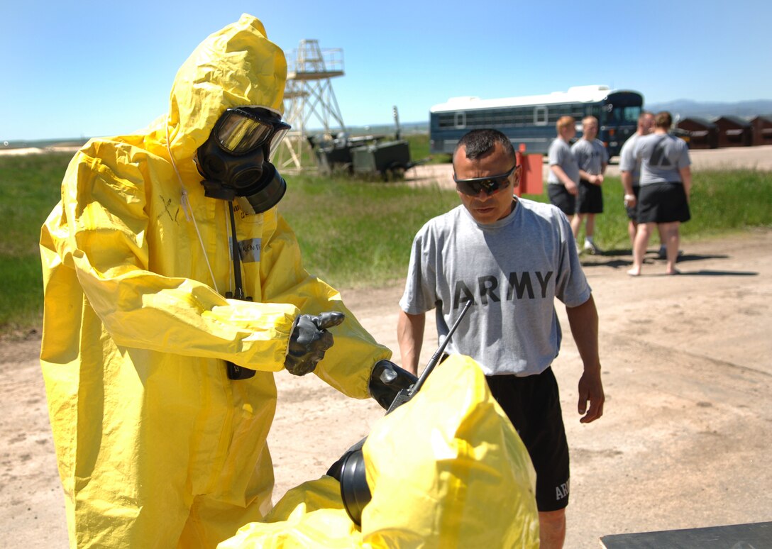 ELLSWORTH AIR FORCE BASE, S.D. -- Private Jose Benavides, Army National Guard, 704th Chemical Company chemical biological radiological and nuclear specialist, is briefing soldiers on the decontamination simulation during the 2010 Golden Coyote exercise at Camp Lancer, Ellsworth Air Force Base, S.D., June 18.  The soldiers are manning a station where simulated casualties in-processed into the tent. (U.S. Air Force photo/Airman 1st Class Jarad Denton)